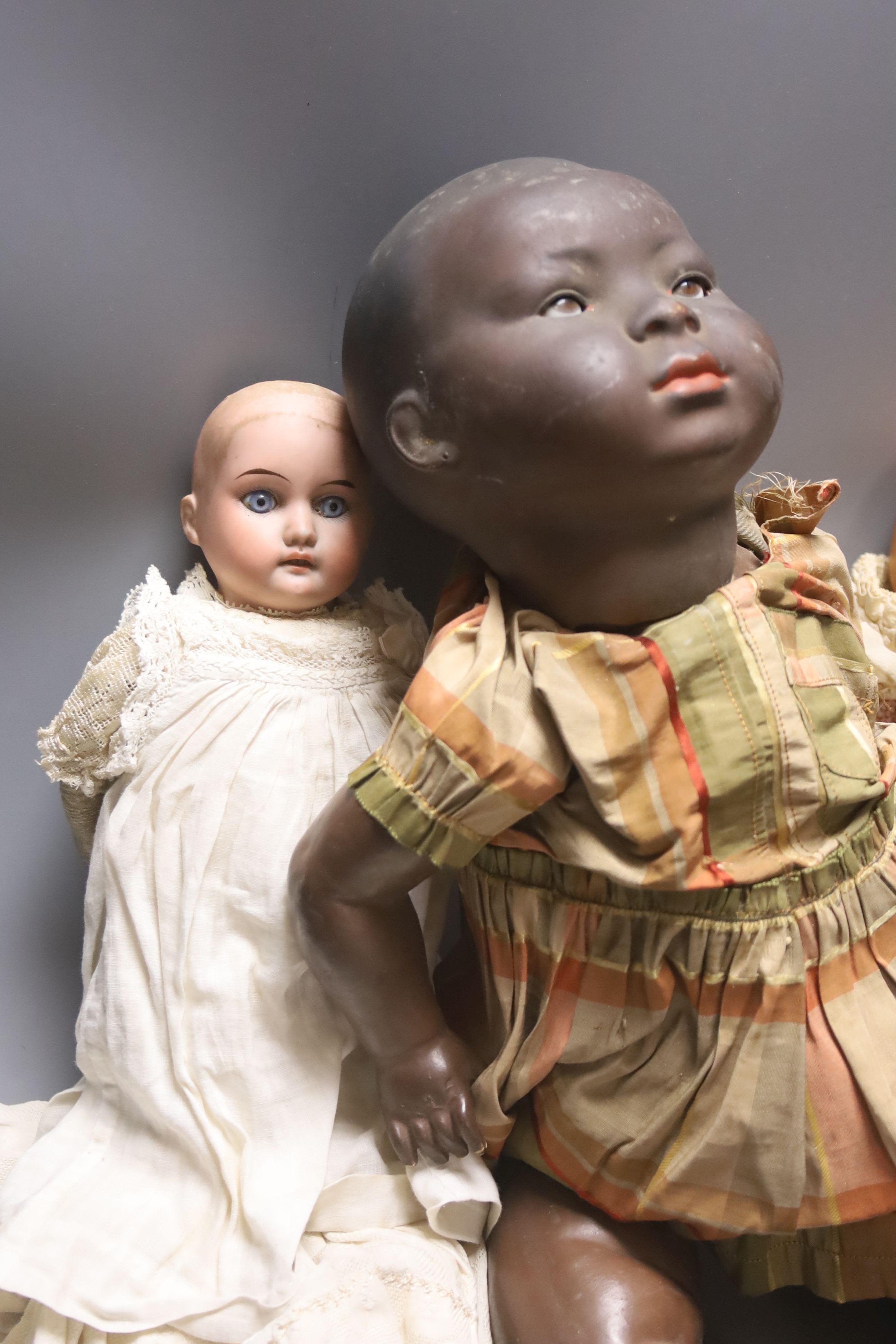 A black bisque-headed doll, German KB-M 5 bent limb with a smaller German bisque open mouth kid leather body doll and an AM Dream baby 351 with open mouth